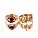 A yellow metal ring, approx. 5gms; and a 9ct gold ring set garnet coloured stone, approx. 5gms (2)