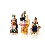 A Victorian Staffordshire figure, of a highland maid with greyhound; another "Mora"; and a seated