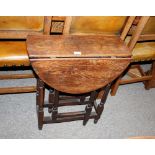 An oak gate leg tea table, the rounded drop leaves raised on turned baluster supports, 60cm