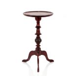 A circular mahogany wine table, the dished top raised on turned column and tripod base, 34cm dia.