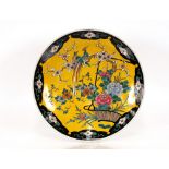 A Japanese Arita ware porcelain charger, of large size , the yellow plateau painted with birds