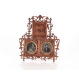 A late 19th Century Black Forest photograph frame, complete with three photographs of a Victorian