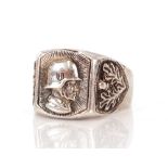 A German Third Reich white metal ring, with helmeted head, and SS emblem having oak leaves and acorn