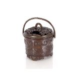 A 19th Century Chinse bronze censer, having swing handle, the pierced lid with a dragon handle,