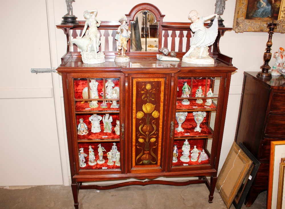 An Art Nouveau mahogany satin wood crossbanded and inlaid display cabinet, having raised mirrored