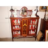 An Art Nouveau mahogany satin wood crossbanded and inlaid display cabinet, having raised mirrored