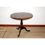 A Georgian mahogany circular tilt top tea table, raised on turned baluster column and tripod base,