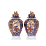 A pair of 19th Century Japanese Imari baluster vases and covers, surmounted by Kylin finials,
