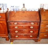 A George III mahogany bureau, the fall front opening to reveal an interior arrangement of drawers