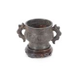 A Chinese bronze censer, with archaic decoration raised on a carved hardwood base AF, 13cm high