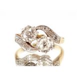 An 18ct gold and platinum diamond set crossover ring