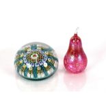 An early 20th Century millefiori paperweight, with spiral canes interspersed with other typical
