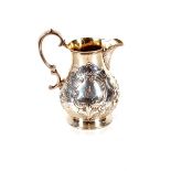 A Victorian baluster milk jug, having rich foliate decoration around a monogrammed cartouche, double