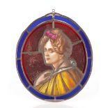 A leaded and stained glass oval panel, depicting a young beauty wearing a yellow cloak and with pink