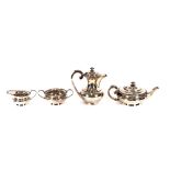 A George V silver four piece tea set, of cushion form having gadrooned borders, the teapot and