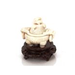 A Chinese carved white jade censer, with ring mask beast handles and lid, 13.5cm wide x 10cm high on