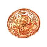 An Hispano Moresque Earthenware deep charger, having pink lustre decoration of a mythical bird,