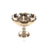 An Edwardian silver pedestal fruit dish, makers mark H W & Co., having foliate pierced border,