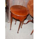 A small mahogany demi-lune fold over tea table, raised on rounded tapering supports and pad feet,