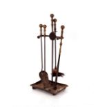 A cast iron and brass mounted companion stand, complete with four implements