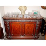 A 19th Century carved mahogany sideboard. by Holland & Sons, having gadrooned border, central drawer