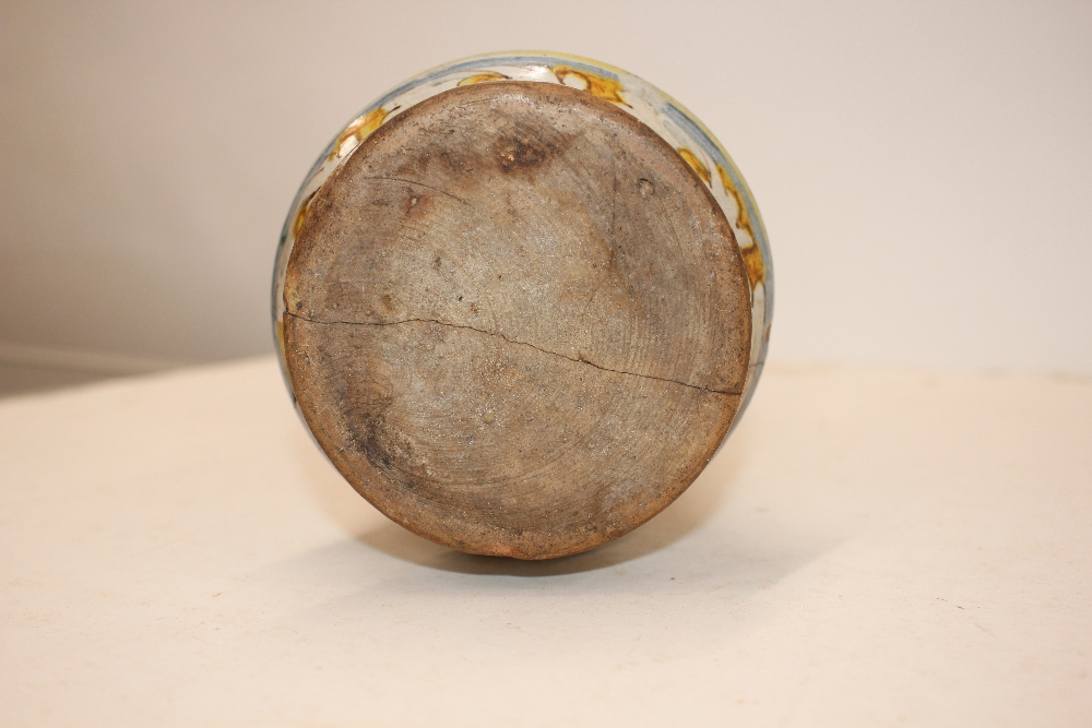 A glazed earthenware albarello, decorated with an oval panel of a priest surrounded by foliate - Image 7 of 8