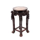 A Chinese hardwood jardinière stand, the shaped beaded top with marble insert raised on foliate