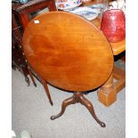 A 19th Century mahogany circular snap top tea table, raised on a turned fluted baluster column and