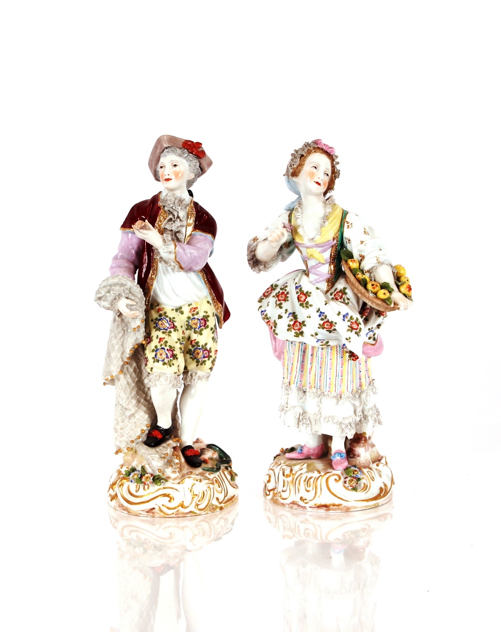 A pair of 19th Century German porcelain figures, depicting street vendors in brightly coloured