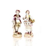 A pair of 19th Century German porcelain figures, depicting street vendors in brightly coloured