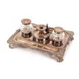 A 19th Century Sheffield plated desk stand, having gadrooned and shell decorated border fitted