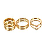 Two 22ct gold wedding bands; and a 22ct gold ring (stone absent), 16.2gms (3)