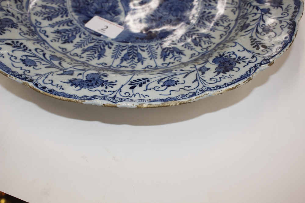 A pair of late 18th Century Delft chargers, central panel decorated with a ho ho bird, surrounded by - Image 12 of 19