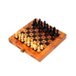 A figured walnut and inlaid folding travelling chess set