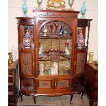 A late Victorian mahogany china display cabinet, the central fabric lined shelves enclosed by a