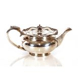 An Edwardian silver teapot, by James Dixon & Sons Sheffield, having shaped foliate border and