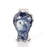 A Delft baluster shouldered vase, decorated with a central panel of a church within foliate