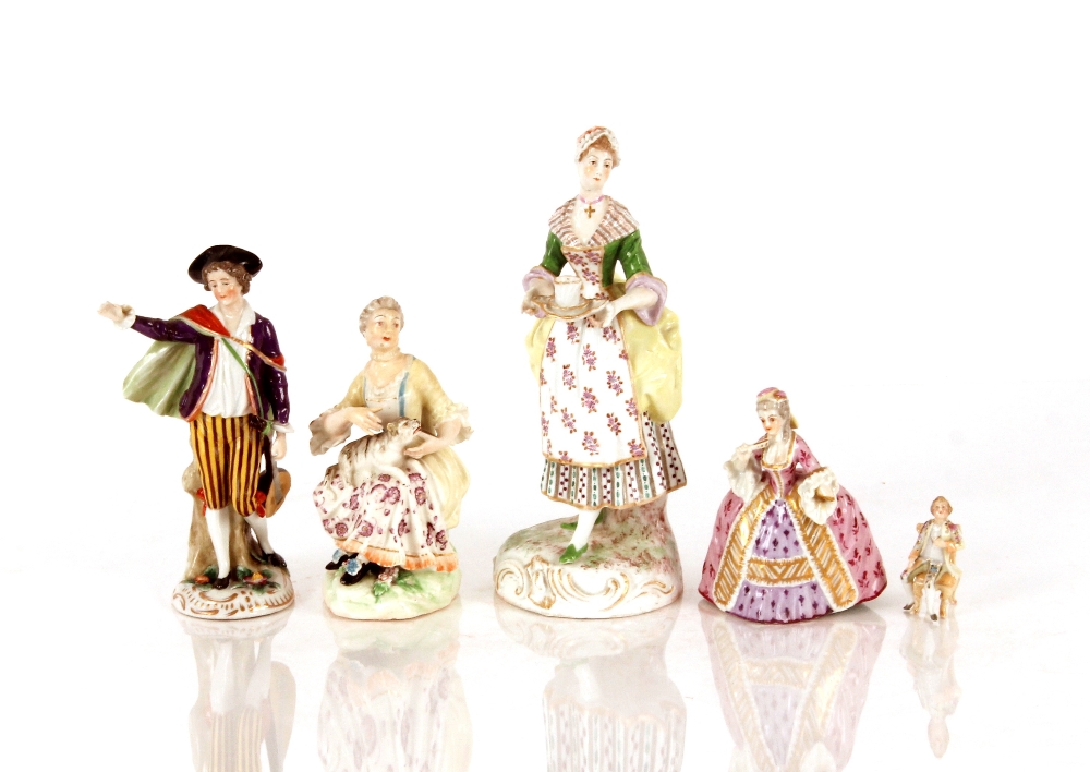 A 19th Century German porcelain figure, of a lady carrying a tea tray, floral decorated and