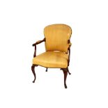 A 19th Century mahogany elbow chair, having upholstered seat, back and armrests, raised on