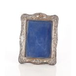 An Edwardian silver mounted photograph frame, with embossed foliate decoration, Birmingham 1902,