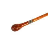 A burr wood walking stick, with silver collar