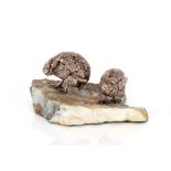 A pair of antique white metal figures, of grouse mounted on a hardstone rock work effect base, 9.5cm