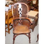 A 19th Century yew wood and elm high back Windsor chair, the pierced central splat and shaped seat