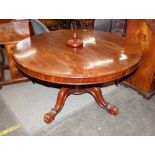 A Victorian mahogany circular extending dining table, raised on baluster column and quadruple