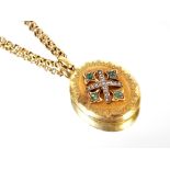 A yellow metal locket, hung to a fine link chain with barrel clasp, inset green and white stones