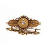 A Victorian 15ct gold bar brooch, having beaded and filigree work decoration set central diamond