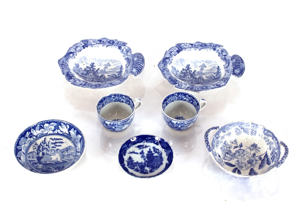 A 19th Century transfer printed miniature tea cup and saucer, decorated rural scenes; a similar cup;