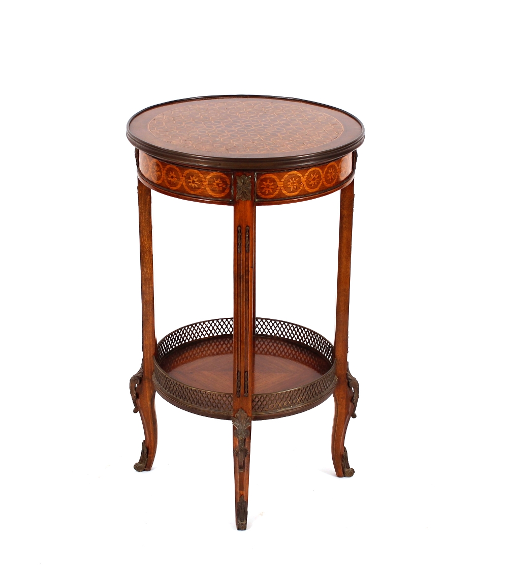 A 20th Century French parquetry decorated two tier occasional table, raised on square columns and