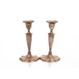 A pair of Edwardian silver baluster candlesticks, of panelled shaped form, Sheffield 1906, 23cm high