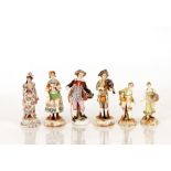 Six various 19th Century German porcelain figures, depicting street vendors, musicians, and a lady